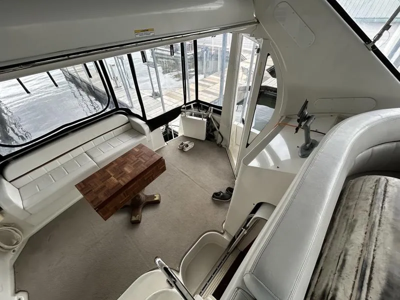 Slide: The Image of Interior of 2005 Carver 396 AFT yacht with seating and wooden table. - 14