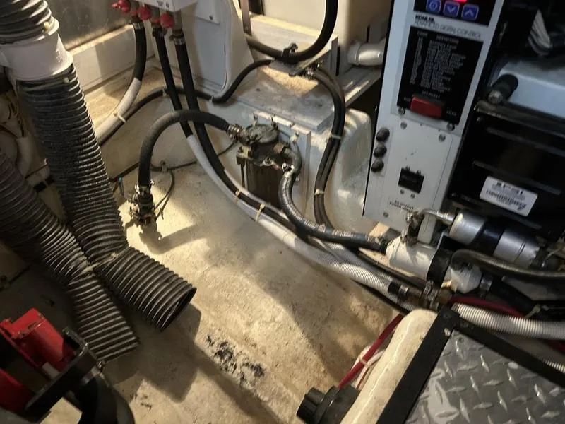 Slide: The Image of Engine room of a 2005 Carver 396 AFT yacht, showing hoses and control panels. - 42