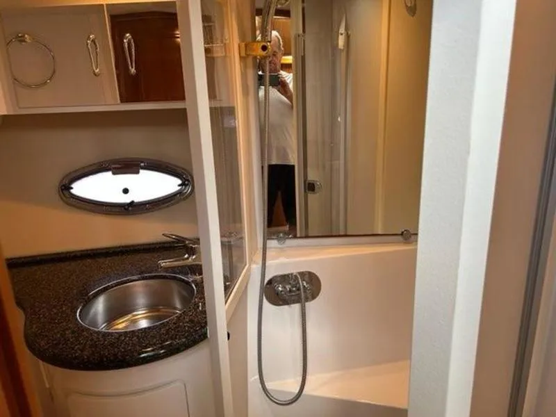 Slide: The Image of 2005 Carver 396 AFT yacht bathroom with sink, shower, and porthole window. - 47