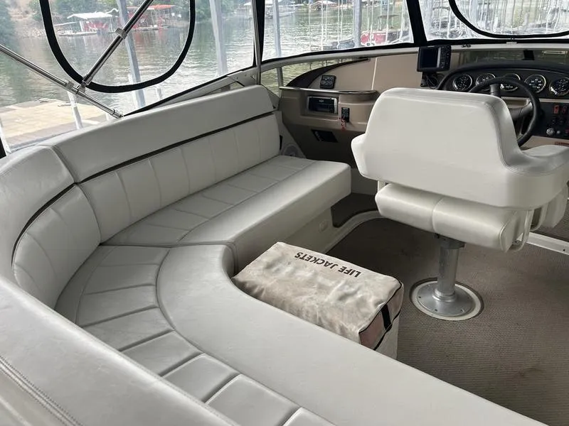 Slide: The Image of Interior of 2005 Carver 396 AFT yacht with white seating and helm station. - 6