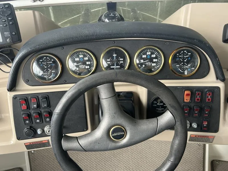 Slide: The Image of Dashboard of a 2005 Carver 396 AFT boat with steering wheel and gauges. - 10