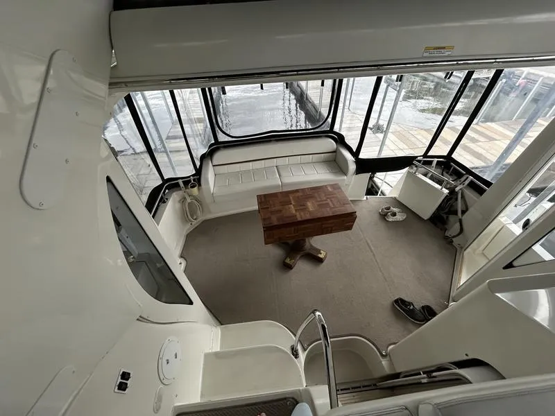 Slide: The Image of Interior of 2005 Carver 396 AFT yacht with seating and wooden table. - 11