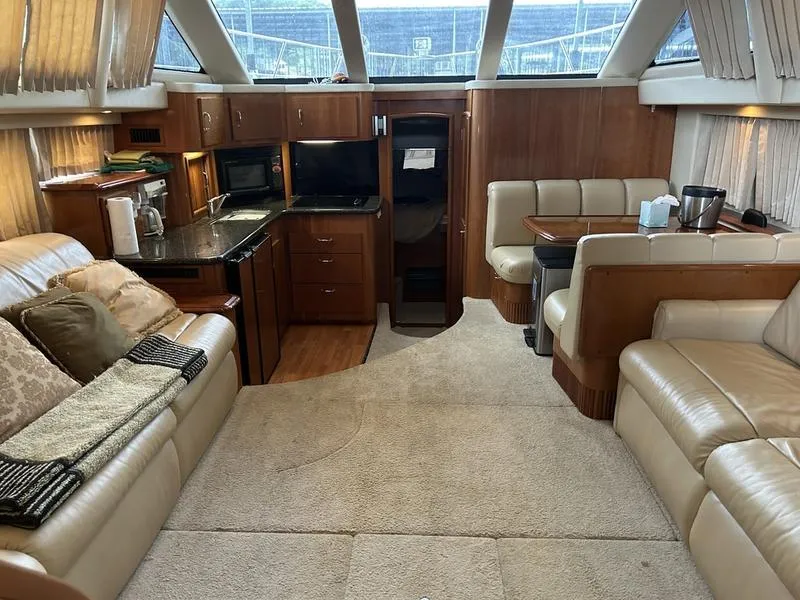 Slide: The Image of Luxurious interior of a 2005 Carver 396 AFT yacht with plush seating and kitchenette. - 15