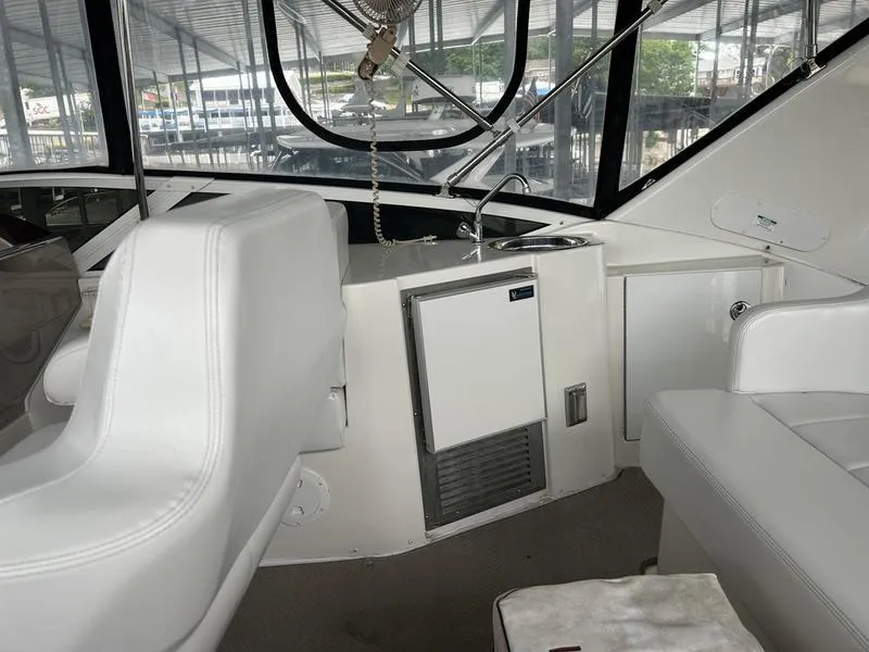 Slide: The Image of Interior of 2005 Carver 396 AFT yacht with white seating and kitchenette. - 16