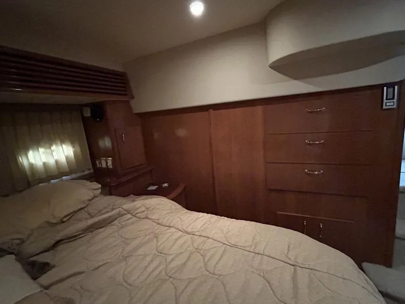Slide: The Image of Interior cabin of 2005 Carver 396 AFT yacht with wood paneling and bed. - 17