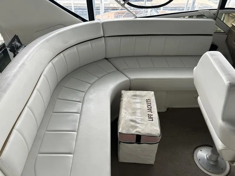 Slide: The Image of 2005 Carver 396 AFT yacht interior with white seating and life jackets storage. - 18