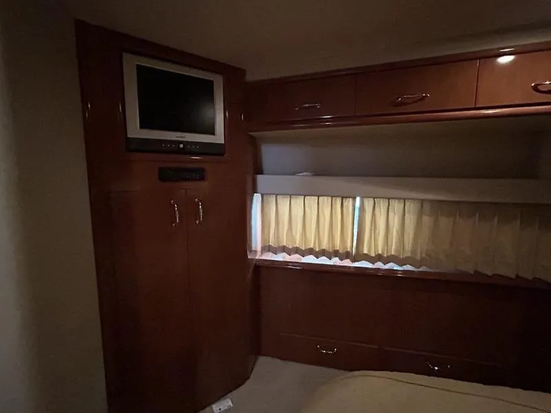 Slide: The Image of Interior of 2005 Carver 396 AFT with TV, cabinets, and curtains. - 19