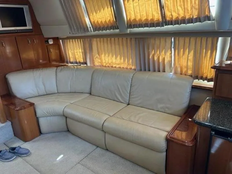 Slide: The Image of Luxurious interior of 2005 Carver 396 AFT yacht with beige leather sofa and wood accents. - 21
