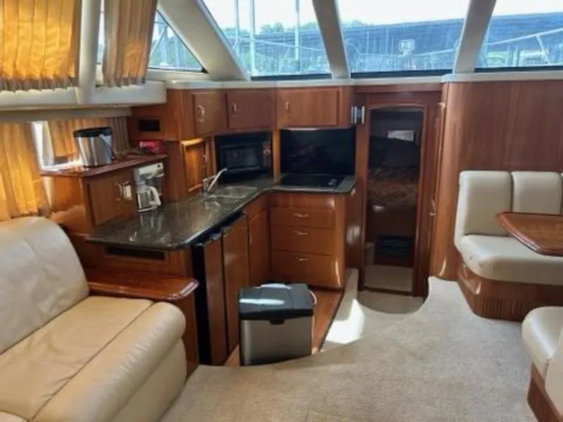 Slide: The Image of Interior of 2005 Carver 396 AFT yacht with kitchen and seating area. - 22