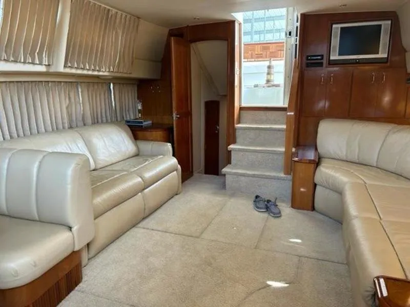 Slide: The Image of Interior of 2005 Carver 396 AFT yacht with beige leather seating and carpeted flooring. - 25