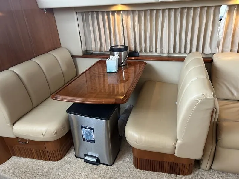 Slide: The Image of Interior of 2005 Carver 396 AFT yacht with dining area and leather seating. - 26