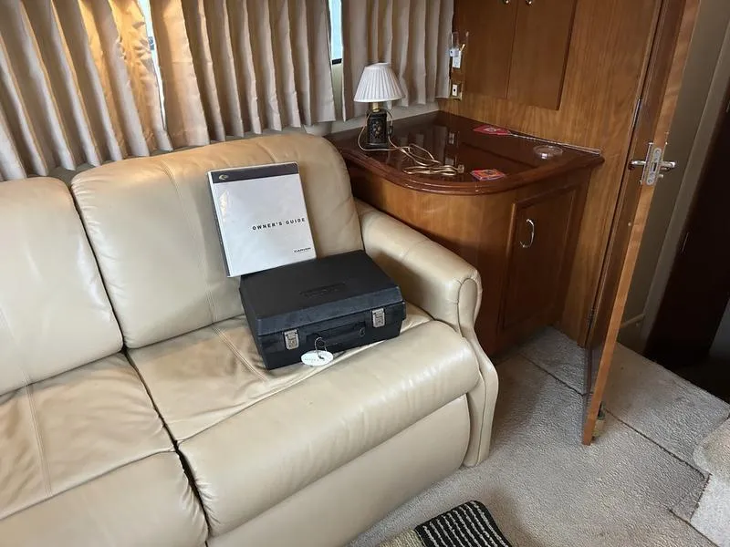 Slide: The Image of Luxurious interior of 2005 Carver 396 AFT yacht with leather sofa and owner's guide. - 27