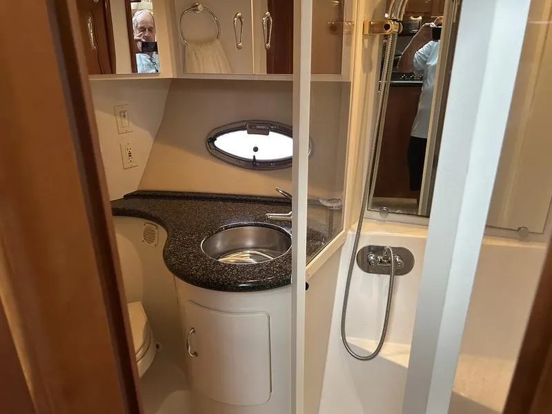 Slide: The Image of 2005 Carver 396 AFT yacht bathroom with sink, shower, and porthole window. - 34
