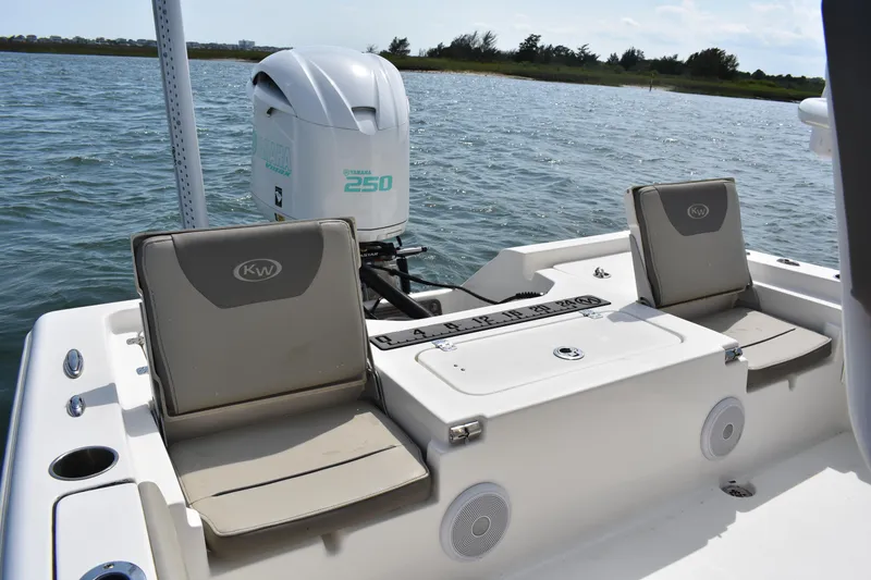 Slide: The Image of 2021 Key West 230 BR boat with seating and outboard motor on a calm lake. - 10