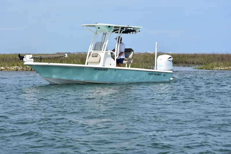 Slide: The Image of 2021 Key West 230 BR boat navigating calm waters near marshland. - 4