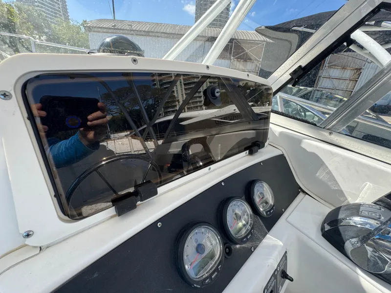 Slide: The Image of 1999 Boston Whaler Conquest 23 dashboard with gauges and steering wheel. - 14