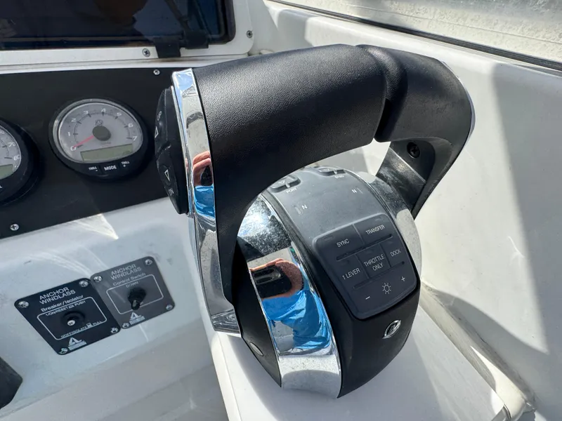 Slide: The Image of 1999 Boston Whaler Conquest 23 boat controls with throttle and gauges. - 17