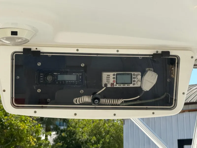 Slide: The Image of 1999 Boston Whaler Conquest 23 dashboard with radio and communication equipment. - 28