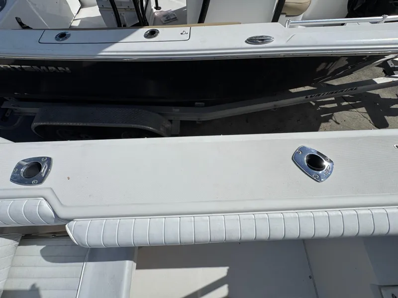 Slide: The Image of 1999 Boston Whaler Conquest 23 boat interior with rod holders and seating. - 33
