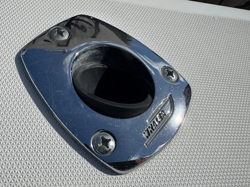 Slide: The Image of Chrome boat fitting on 1999 Boston Whaler Conquest 23, featuring textured surface. - 35
