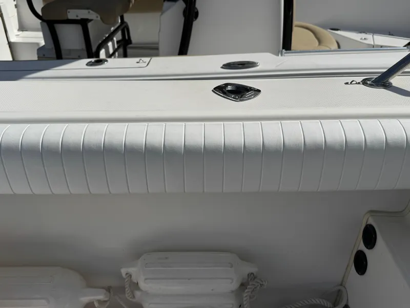 Slide: The Image of 1999 Boston Whaler Conquest 23 boat interior with seating and storage compartments. - 36