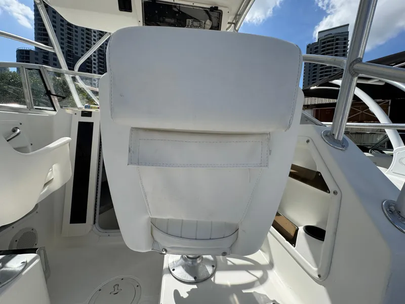 Slide: The Image of 1999 Boston Whaler Conquest 23 boat interior with white seating and modern design. - 39