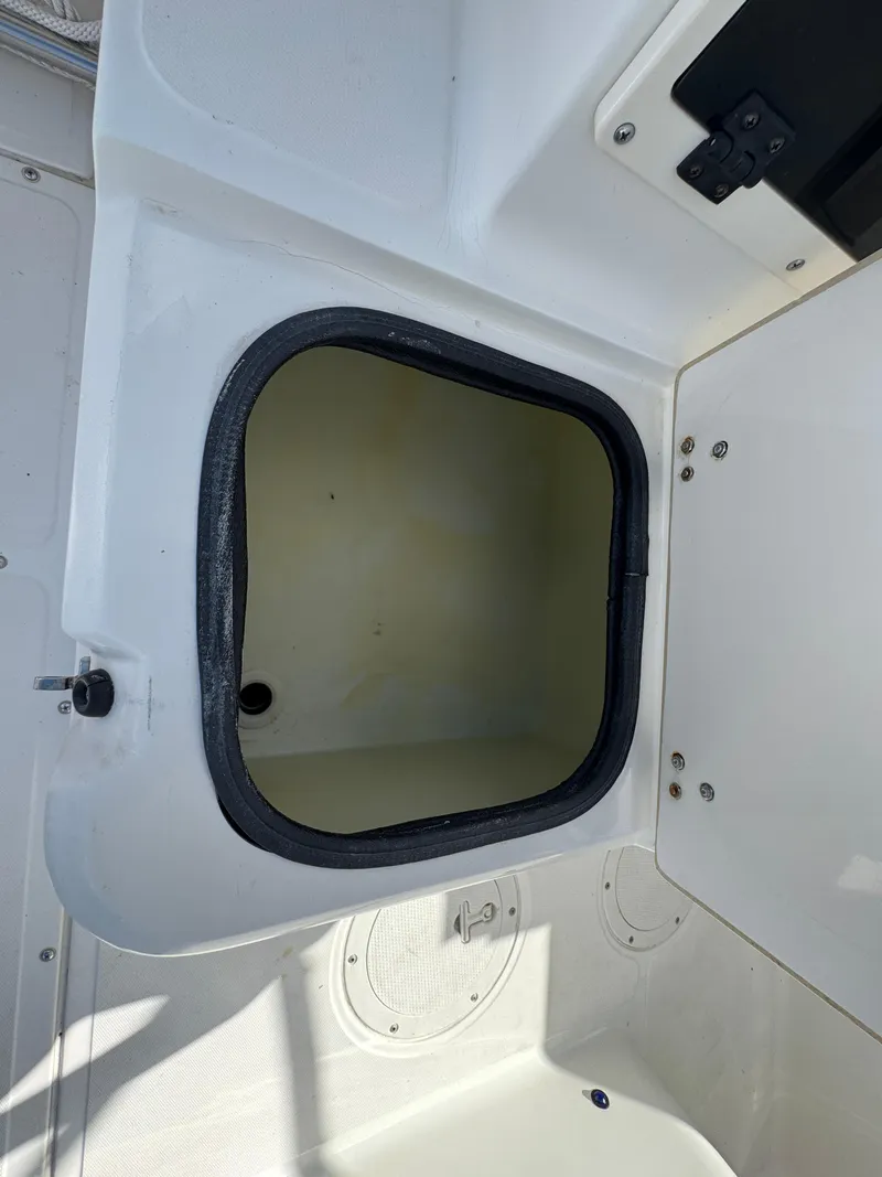 Slide: The Image of Open storage compartment on a 1999 Boston Whaler Conquest 23 boat. - 41