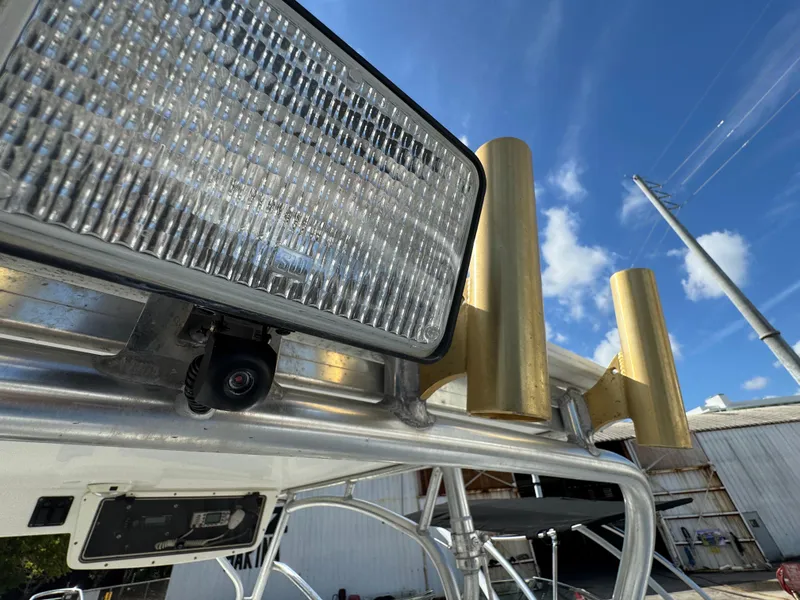 Slide: The Image of Close-up of 1999 Boston Whaler Conquest 23 boat's light and rod holders under blue sky. - 47
