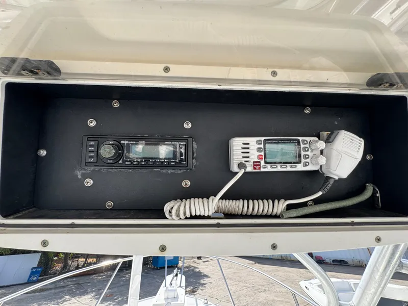 Slide: The Image of 1999 Boston Whaler Conquest 23 dashboard with radio and communication equipment. - 50
