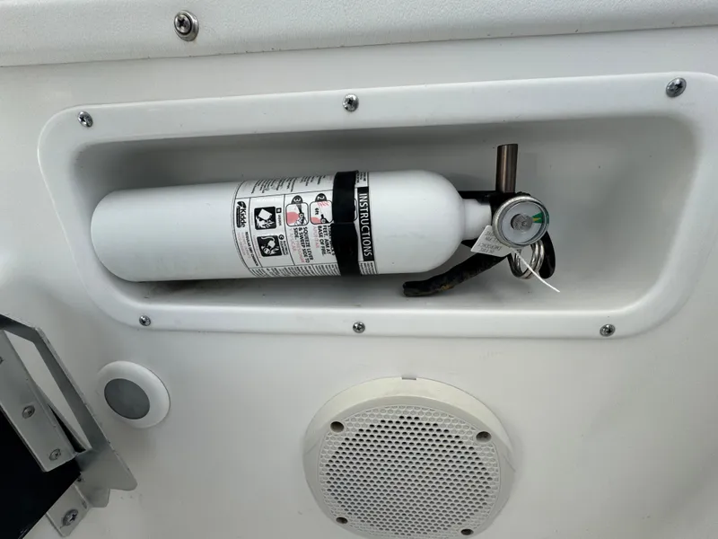 Slide: The Image of Fire extinguisher mounted on a 1999 Boston Whaler Conquest 23 boat. - 52