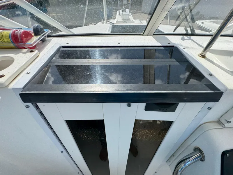Slide: The Image of 1999 Boston Whaler Conquest 23 cockpit with glass panel and stainless steel details. - 6