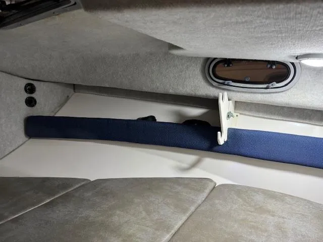 Slide: The Image of Interior cabin of 1999 Boston Whaler Conquest 23 boat, featuring seating and storage. - 8