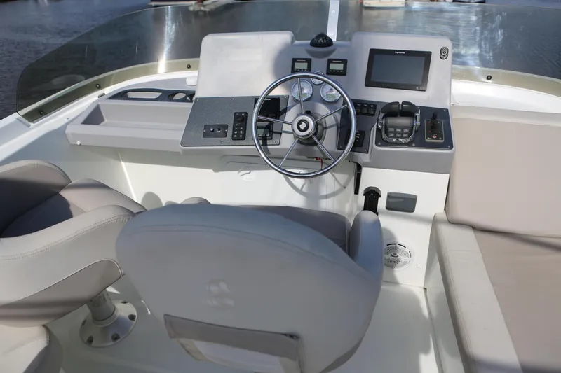 Slide: The Image of Helm of 2020 Beneteau Swift Trawler 44 with steering wheel and navigation controls. - 31