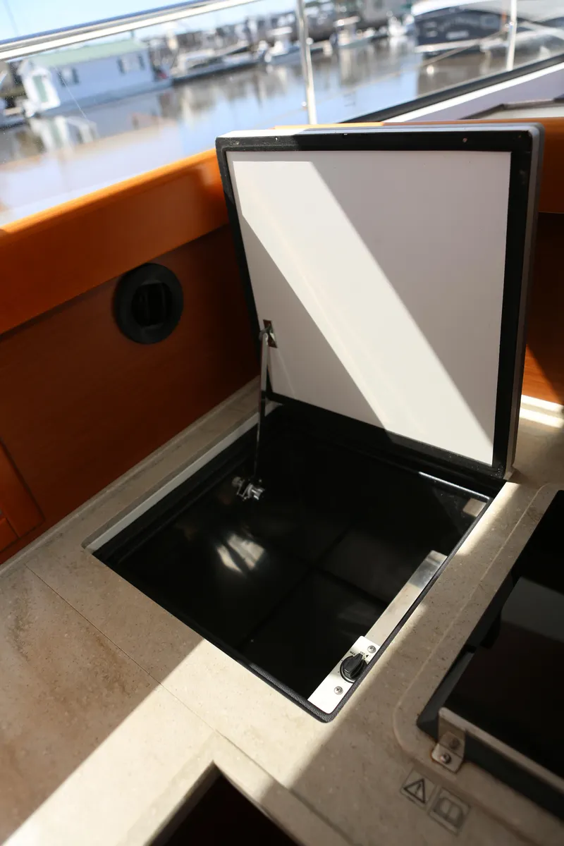 Slide: The Image of Open storage compartment on 2020 Beneteau Swift Trawler 44 yacht deck. - 6