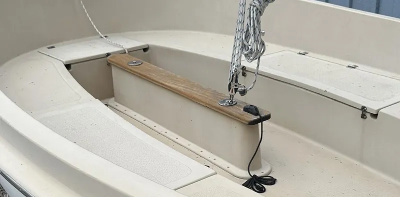 Slide: The Image of 2001 Com-Pac Picnic Cat sailboat interior with wooden bench and rigging. - 6