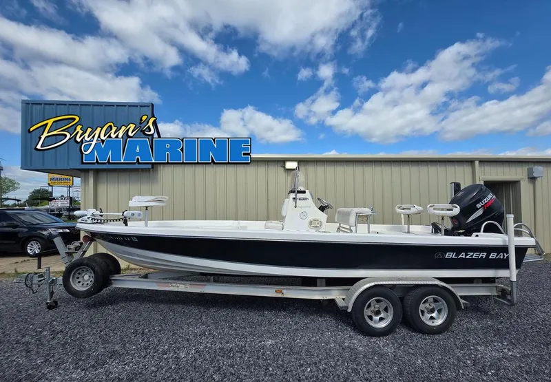 Slide: The Image of 2008 Blazer Bay 2420 Professional boat on trailer at Bryan's Marine dealership. - 2