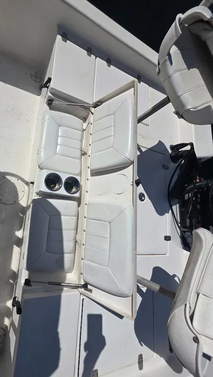 Slide: The Image of 2008 Blazer Bay 2420 Professional boat interior with white seating and cup holders. - 20