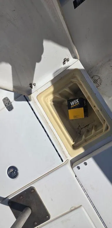 Slide: The Image of Open compartment on 2008 Blazer Bay 2420 Professional boat with Wix filter inside. - 22