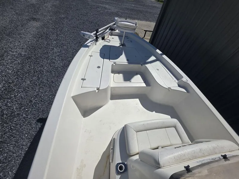 Slide: The Image of 2008 Blazer Bay 2420 Professional boat with seating and storage, parked on gravel. - 26