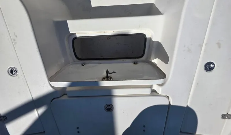 Slide: The Image of 2008 Blazer Bay 2420 Professional boat compartment with open hatch and visible latch mechanism. - 28