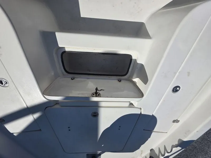 Slide: The Image of 2008 Blazer Bay 2420 Professional boat storage compartment, open lid, white interior. - 29