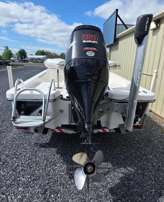 Slide: The Image of 2008 Blazer Bay 2420 Professional boat with Suzuki 250 engine, parked on gravel. - 5