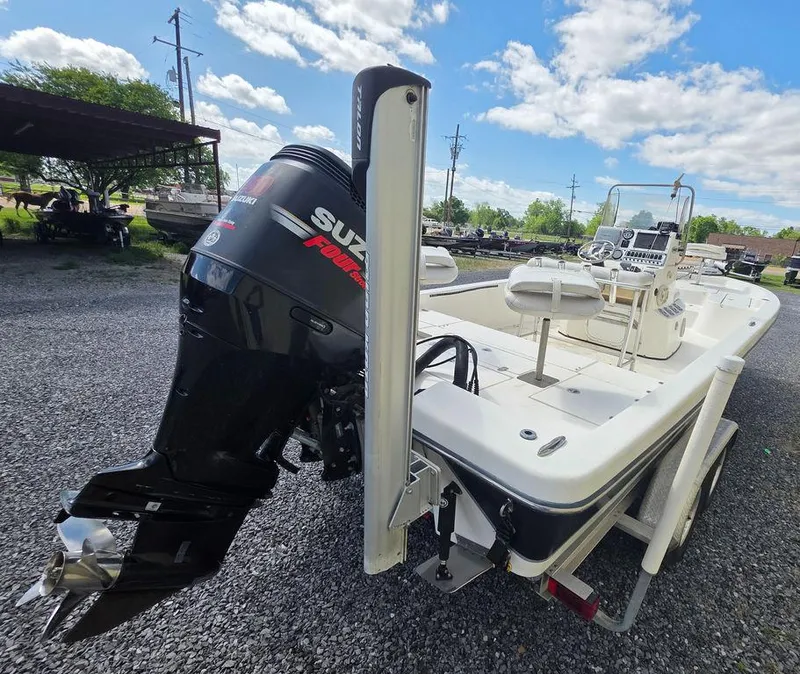 Slide: The Image of 2008 Blazer Bay 2420 Professional boat with Suzuki outboard motor, parked on gravel. - 6