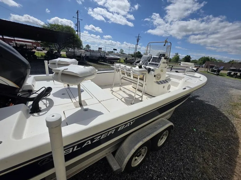 Slide: The Image of 2008 Blazer Bay 2420 Professional boat on trailer under a sunny sky. - 7