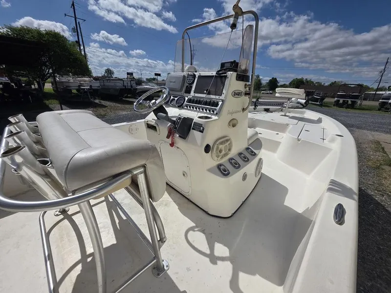 Slide: The Image of 2008 Blazer Bay 2420 Professional boat with steering console and seating, outdoors under blue sky. - 8