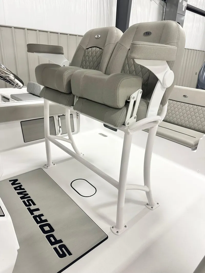 Slide: The Image of 2025 Sportsman Masters 247OE Bay Boat seating with cushioned dual chairs and white frame. - 4