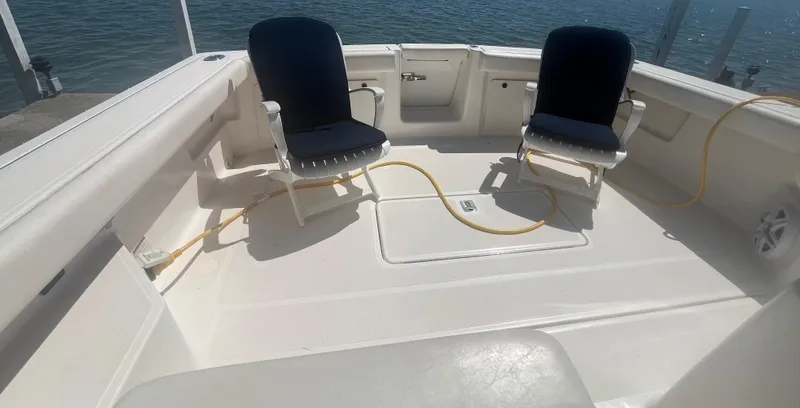 Slide: The Image of 2007 Tiara Yachts 2900 Coronet deck with two chairs, docked by the water. - 12