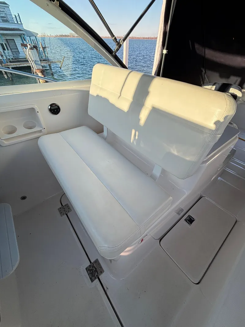 Slide: The Image of 2007 Tiara Yachts 2900 Coronet interior with white seating and waterfront view. - 20