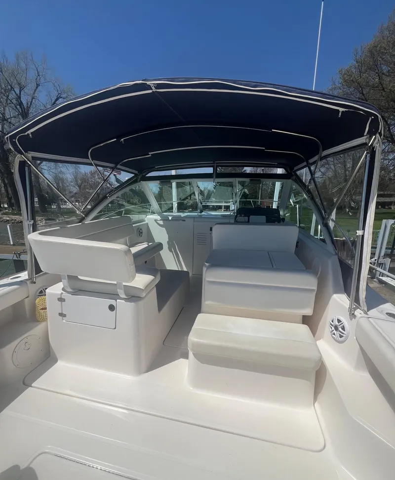 Slide: The Image of 2007 Tiara Yachts 2900 Coronet with canopy, spacious seating, and sleek design. - 21