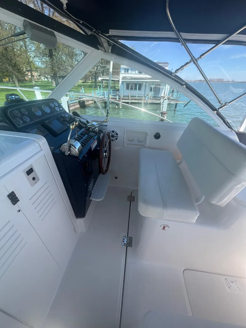 Slide: The Image of 2007 Tiara Yachts 2900 Coronet cockpit with helm, seating, and waterfront view. - 23